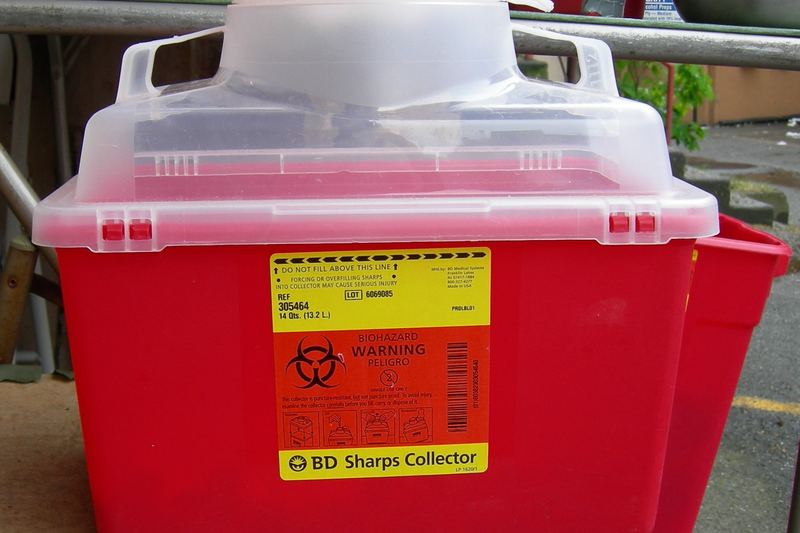 Yellow sharps disposal container