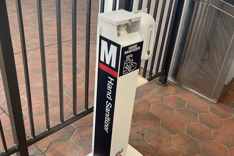 Hand sanitiser dispenser stand in a public space